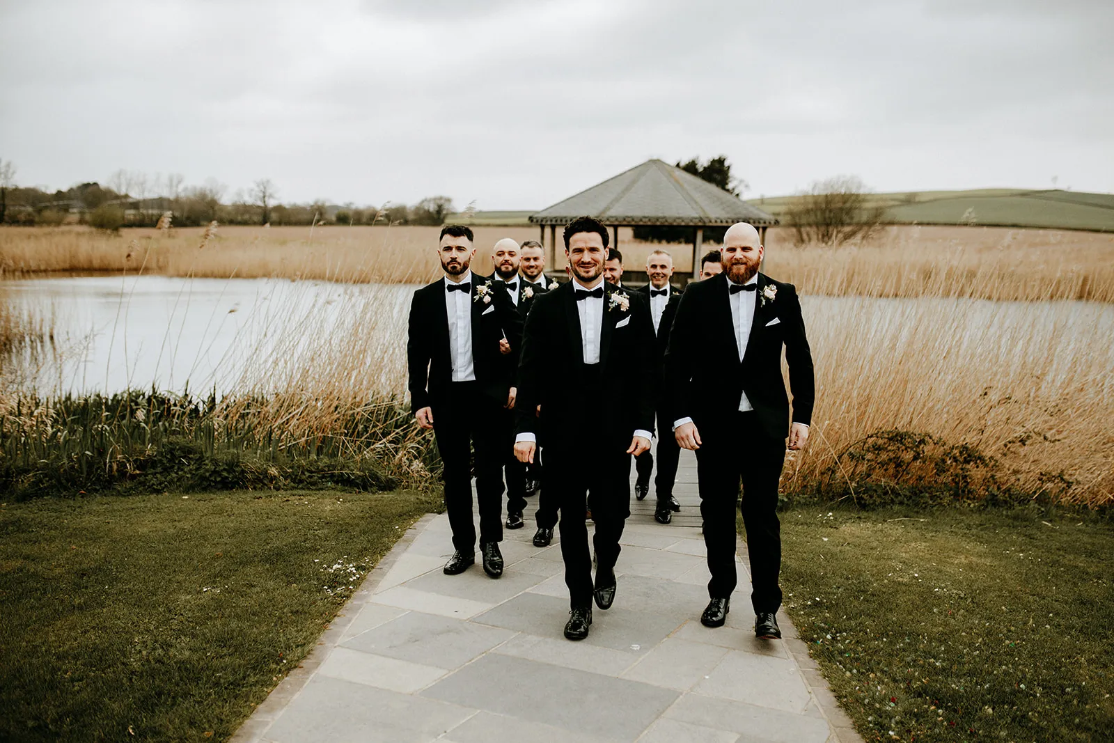 Quantock Lakes Wedding Venue groomsmen walking toward camera